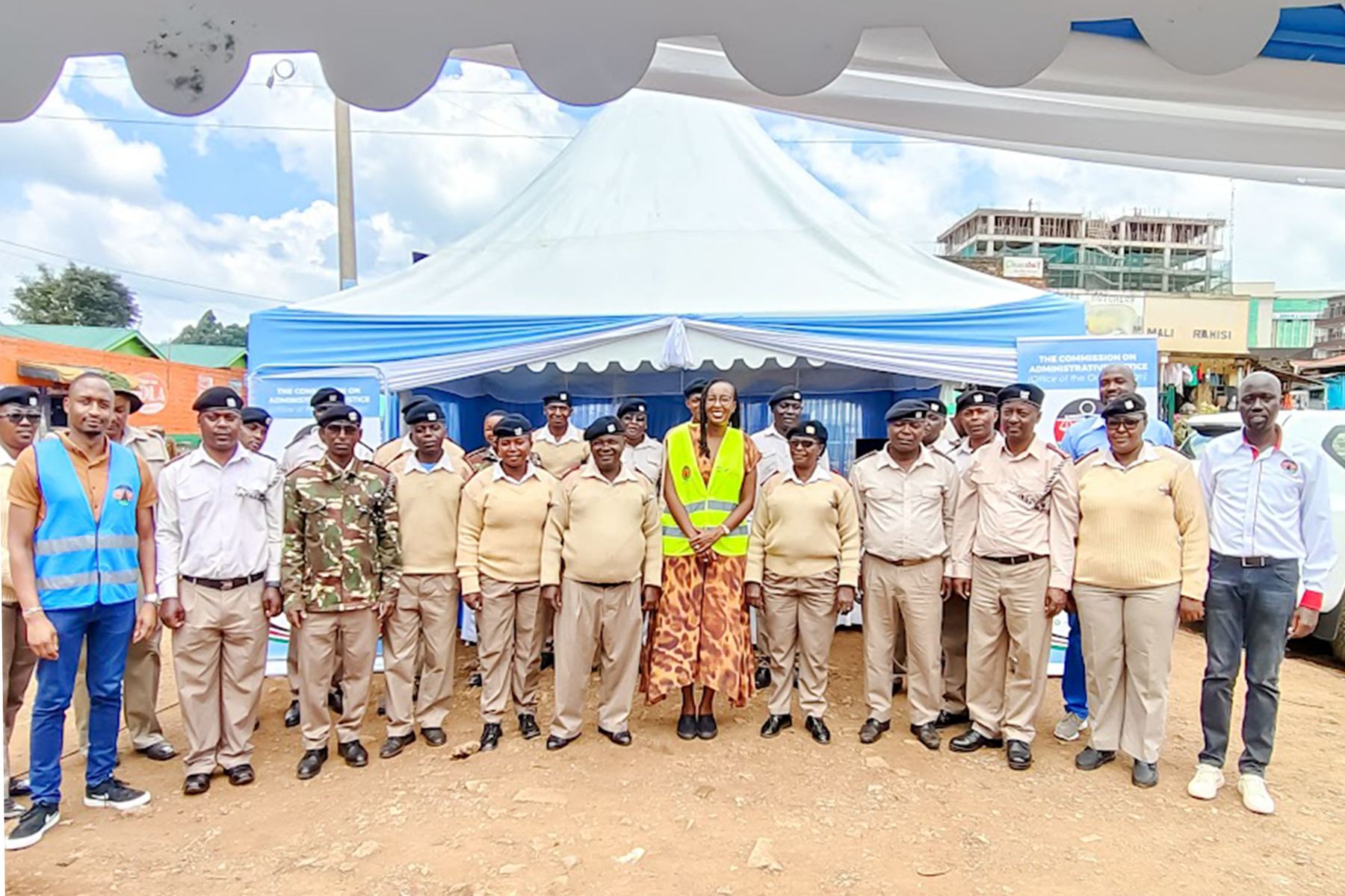 The Vice Chairperson standing with uniformed chiefs and assistant chiefs in front of the Commission's outreach tent.